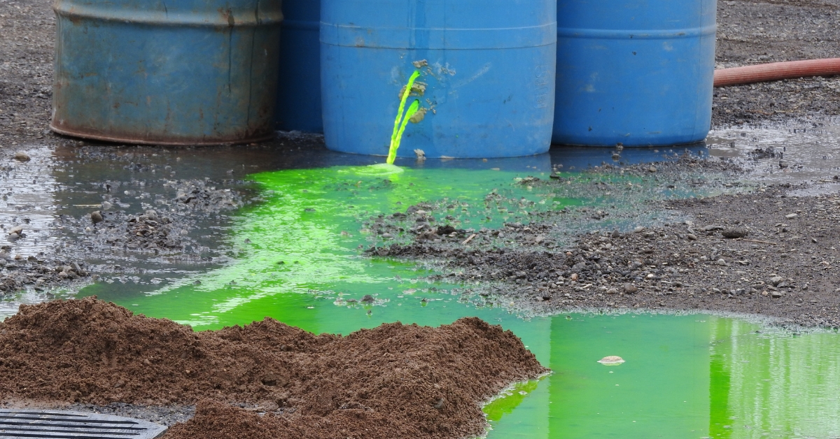 A chemical spill from a blue 210L drum